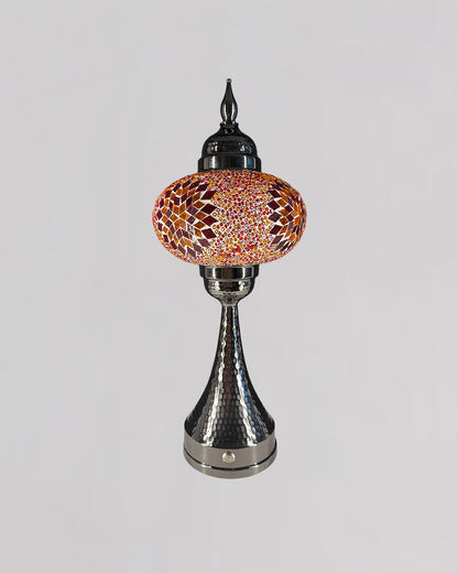 Decorative lamp with mosaic glass shade on a gray background