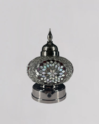 Decorative lamp with mosaic design on a white background