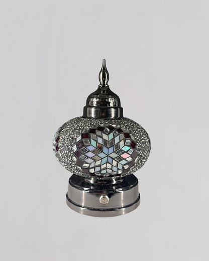 Decorative lamp with mosaic design on a gray background