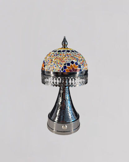 Decorative lamp with a colorful mosaic top on a gray background
