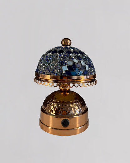 Decorative bell with mosaic top on a light gray background